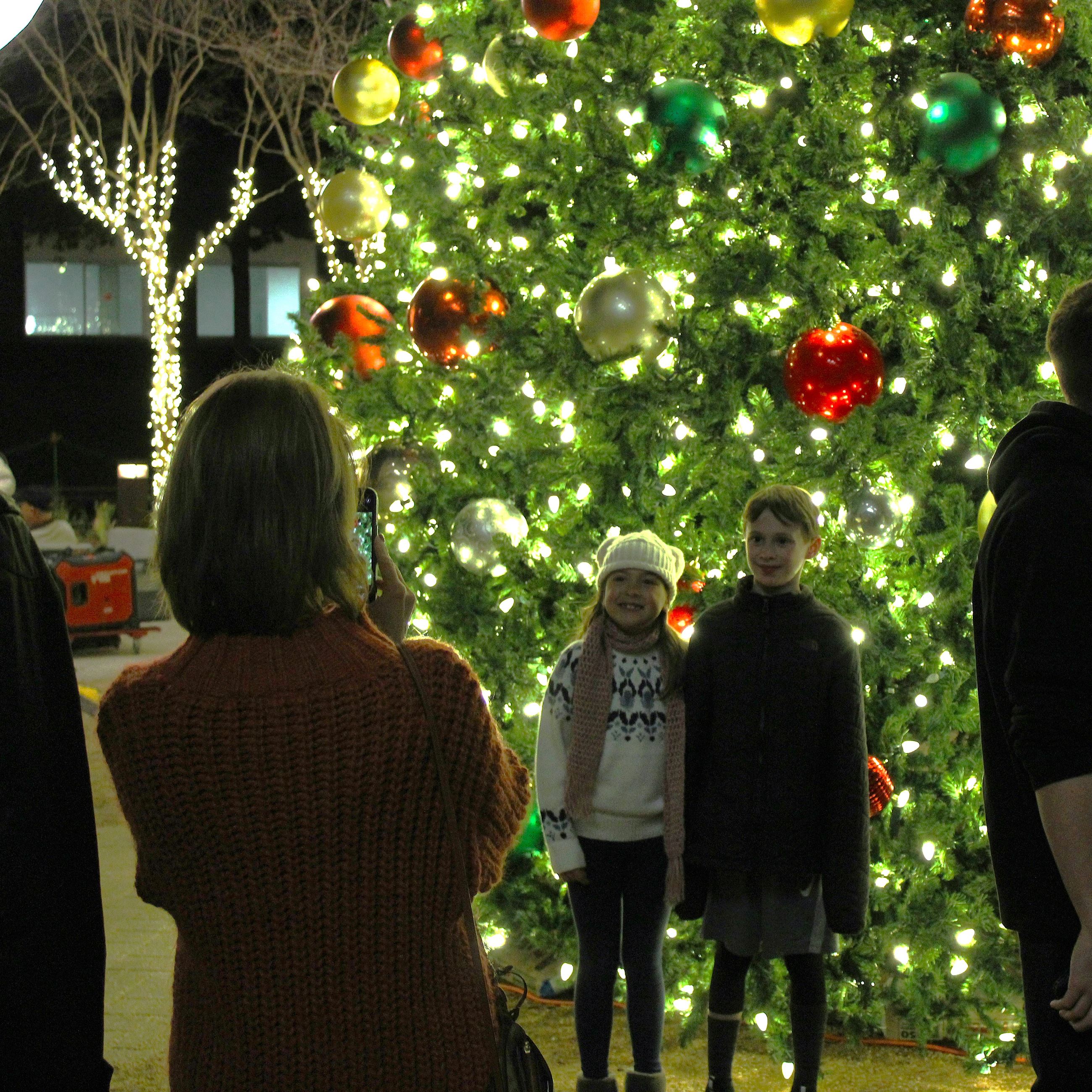 Taking photos in front of the Christmas Tree